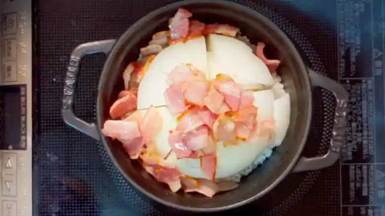 玉ねぎとベーコンが入った鍋を上から撮影した写真です。ベーコンはフライパンで炒めてあります。