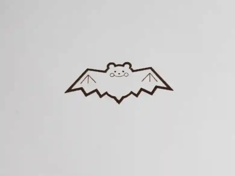 This illustration is of a bat, the trademark ofCafé Shinkokan. The mouth of the bat looks like it is smiling. The character "bat" has the same sound as the Chinese word "hefuku（変福）," which means "to be blessed. For this reason, the bat was a lucky charm in ancient China to bring good fortune.