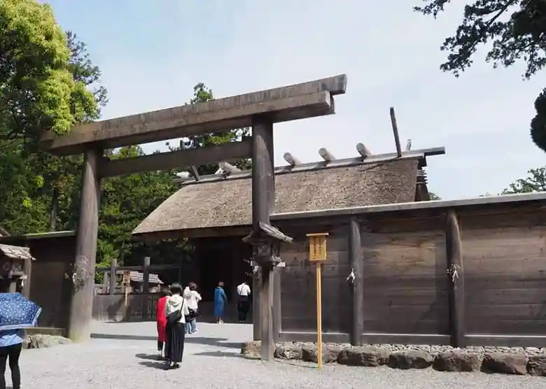 This photograph shows Toyouke Daijingu, the Shogu of the Geku at Ise Grand Shrine. A wooden torii gate stands at the entrance, and a wooden fence surrounds the building. Worshippers cannot see the shrine pavilions from the outside.