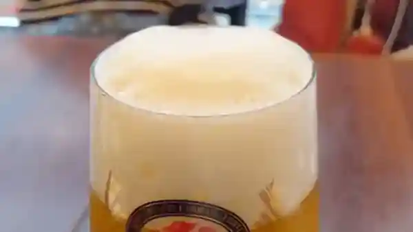 This picture shows a glass of Heartland beer with fine foam.