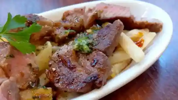 This picture shows a lamb steak called "Lamb Teki," about 1 cm thick. It is served with French fries.