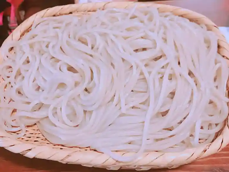 This is a photo of soba noodles served on a colander.