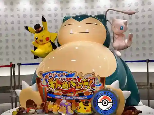 This photo depicts a giant Snorlax standing about 2 meters tall. Pikachu can be seen on Snorlax's right shoulder, while Mew is perched on its left.